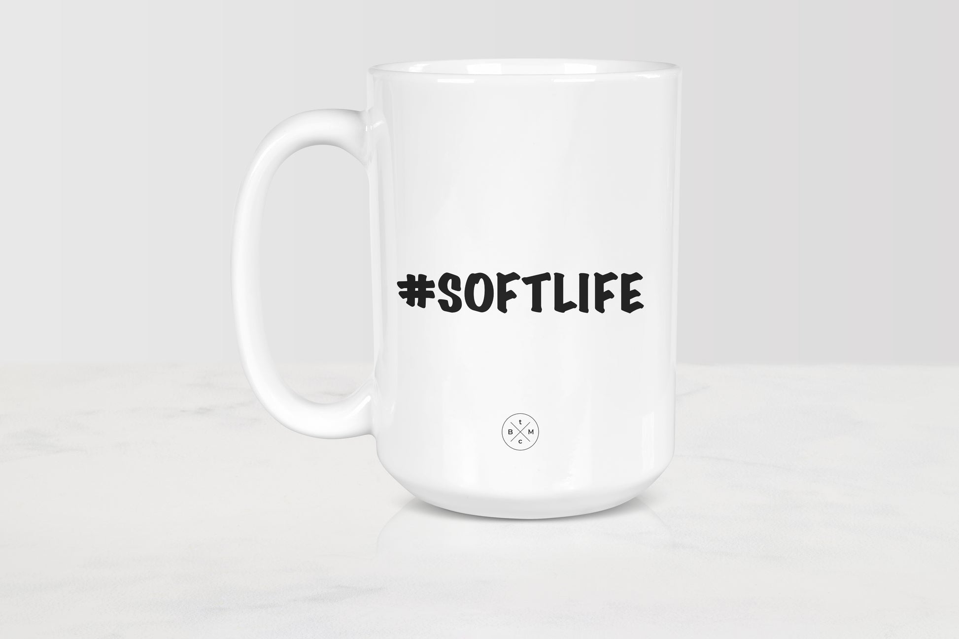 White 15 ounce ceramic mug with black text #SoftLife