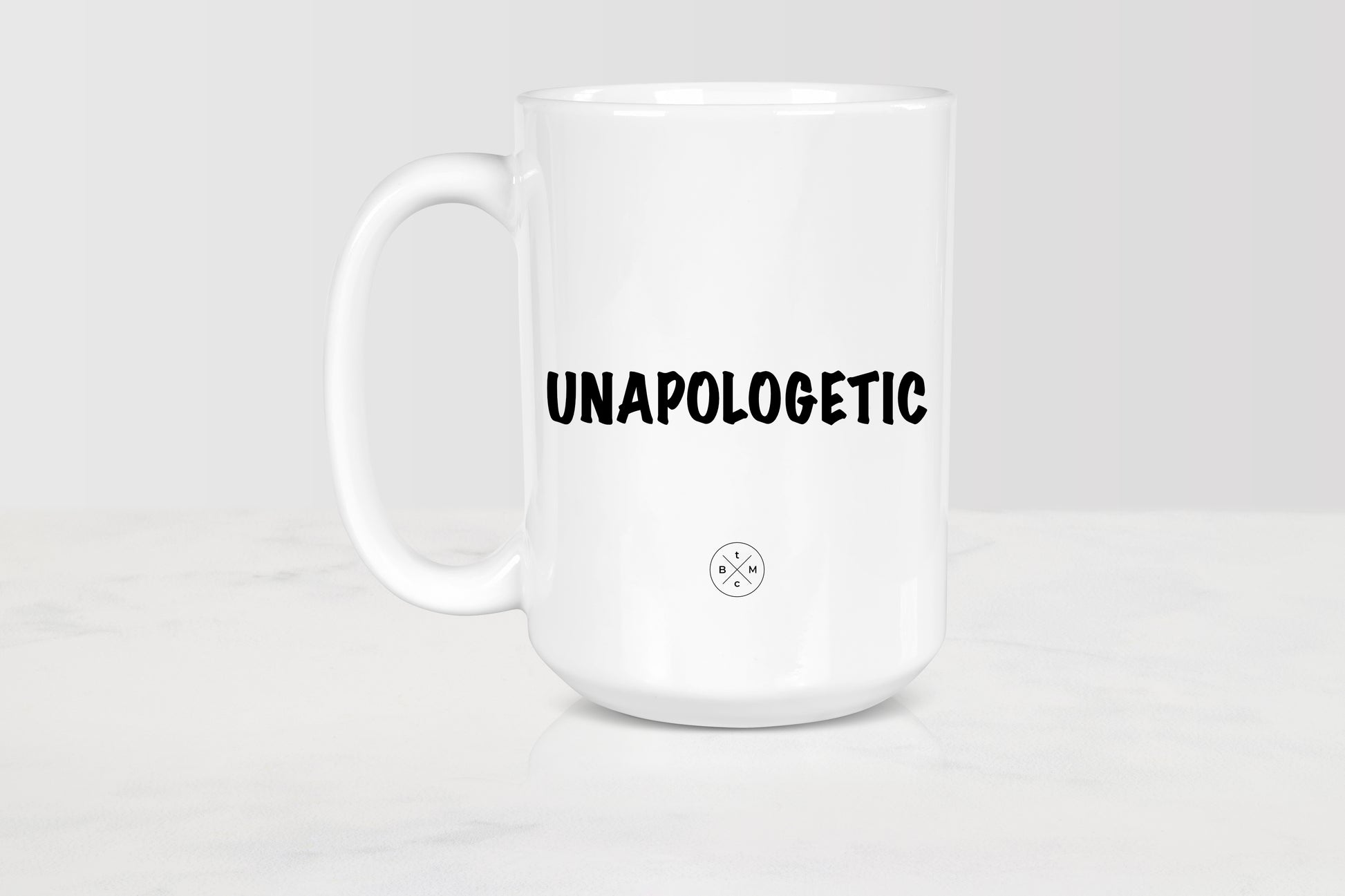 15 ounce white ceramic mug with black  text unapologetic