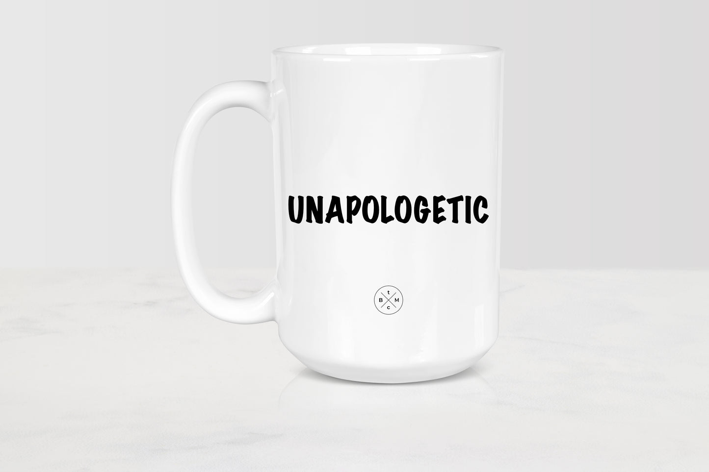 15 ounce white ceramic mug with black  text unapologetic