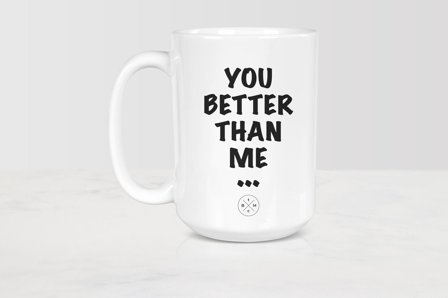 White 15 ounce ceramic mug with black text you better than me