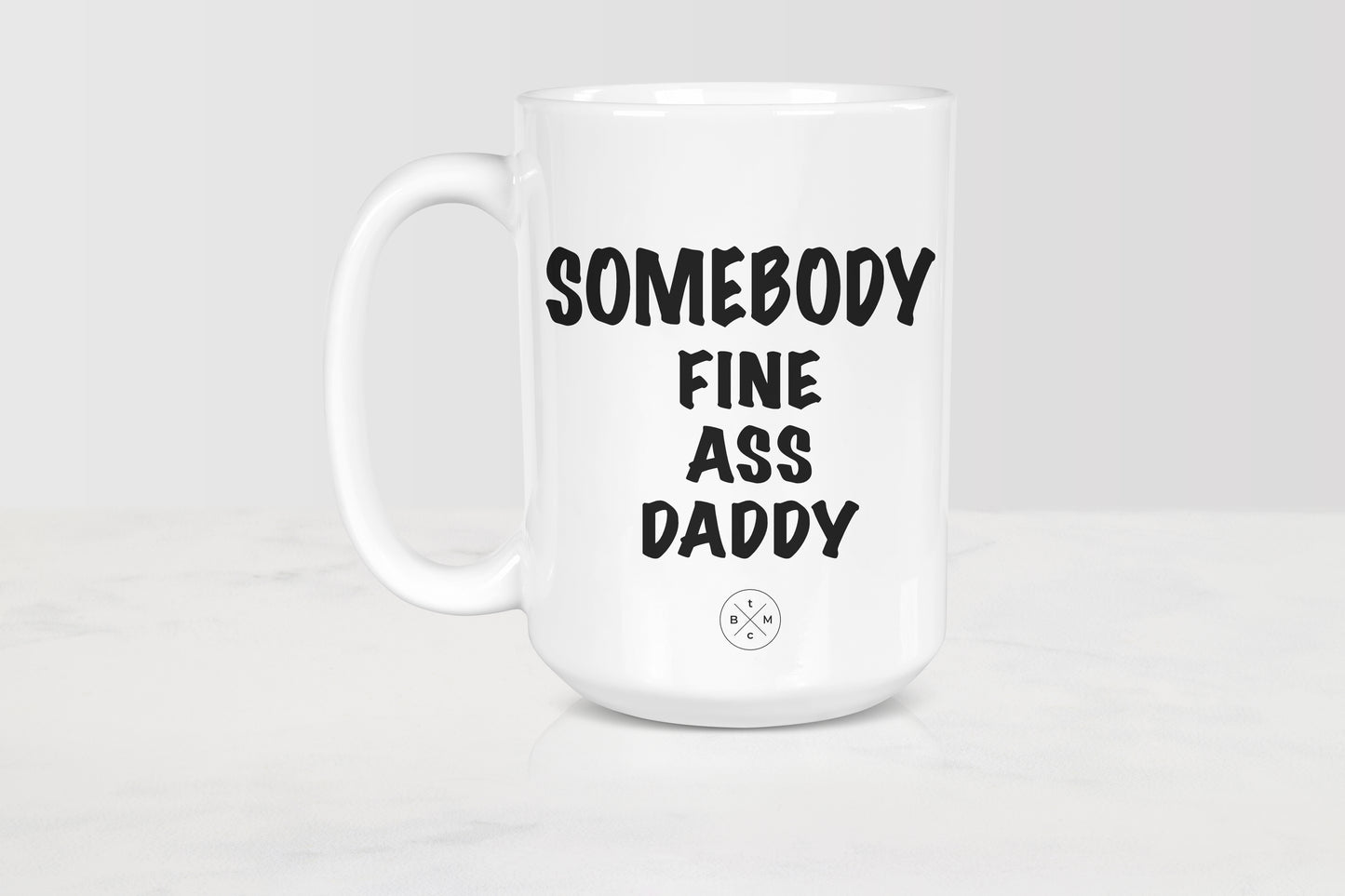 15 ounce white ceramic mug with black text somebody fine ass daddy