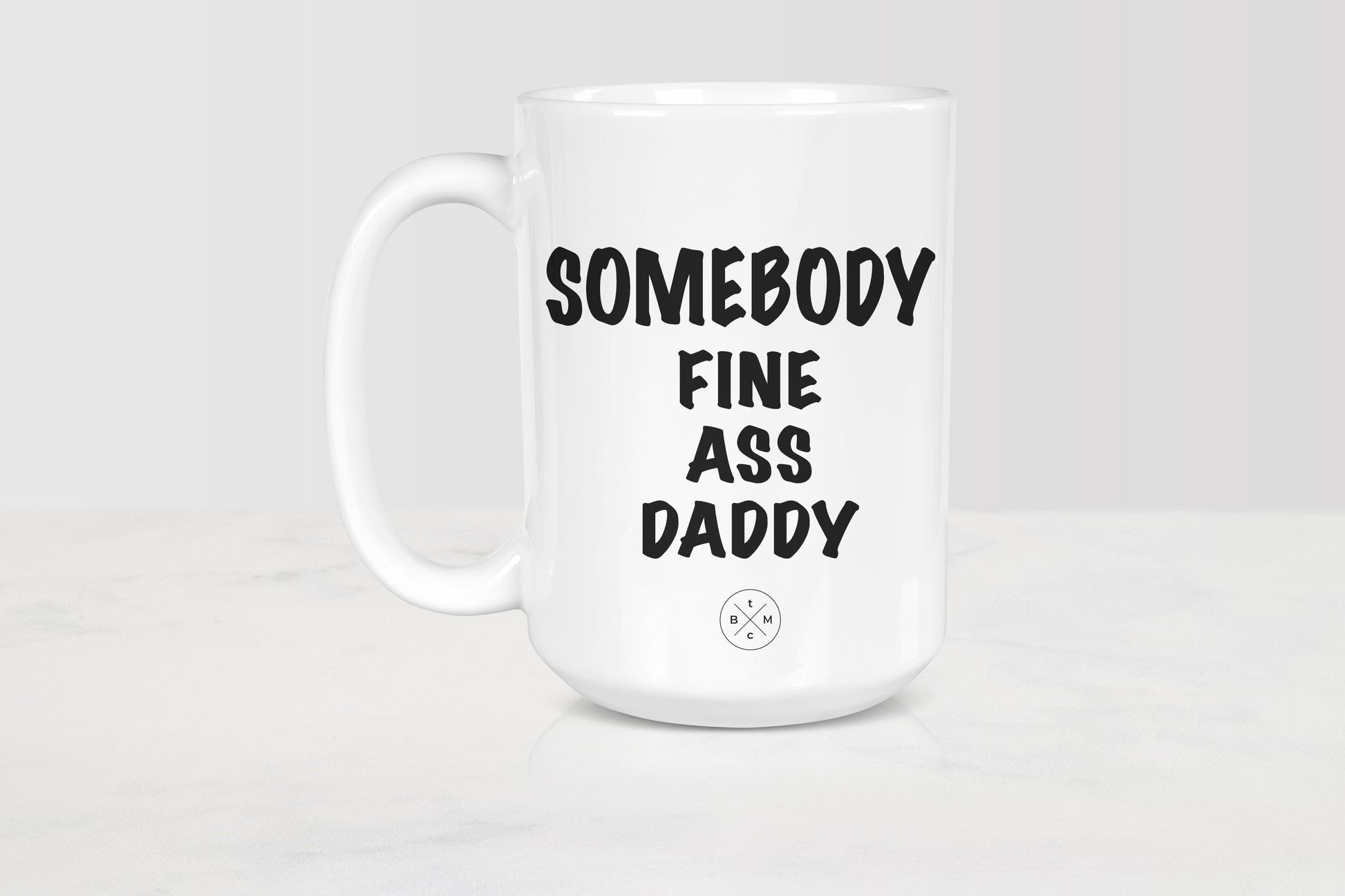 15 ounce white ceramic mug with black text somebody fine ass daddy
