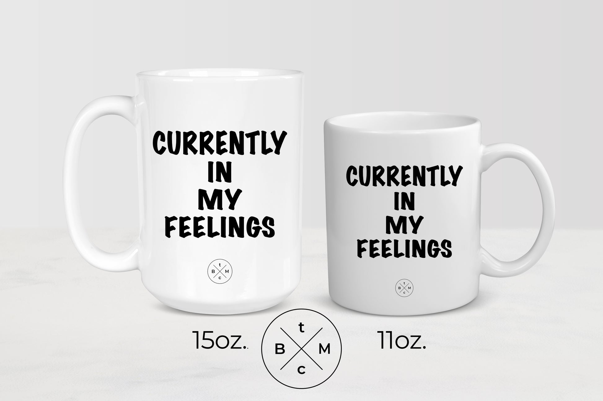 11 ounce and 15 ounce white ceramic mugs with black text currently in my feelings