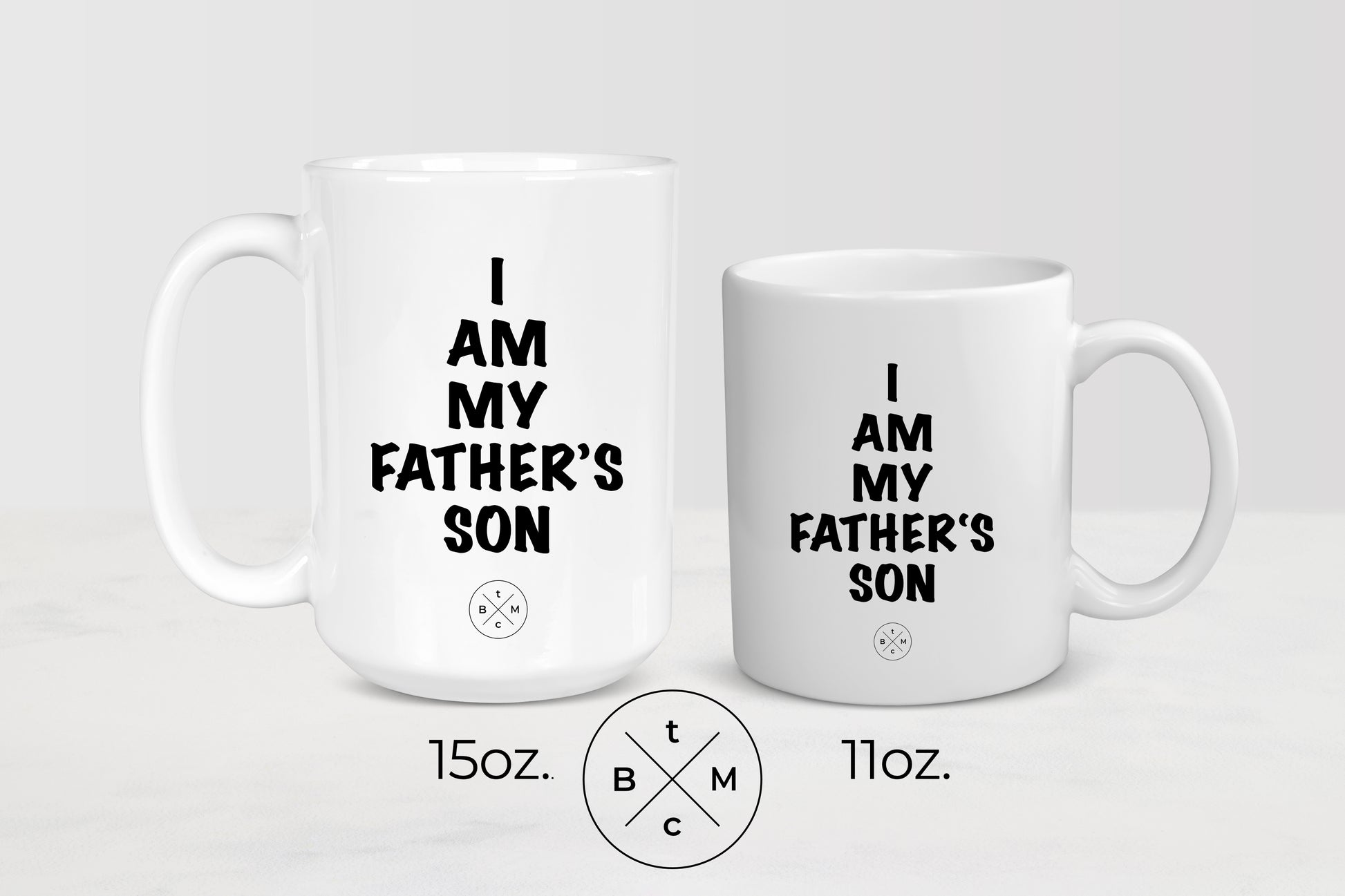 11 ounce and 15 ounce white ceramic mugs with black text I am my father’s son