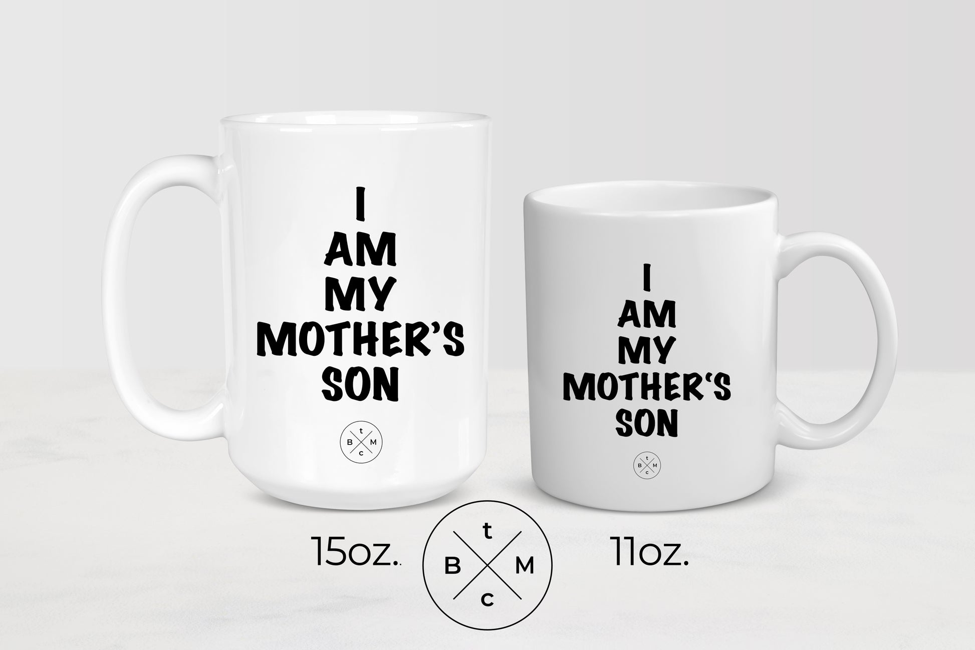 11ounce and 15 ounce white ceramic mugs with black text I am my mother’s son