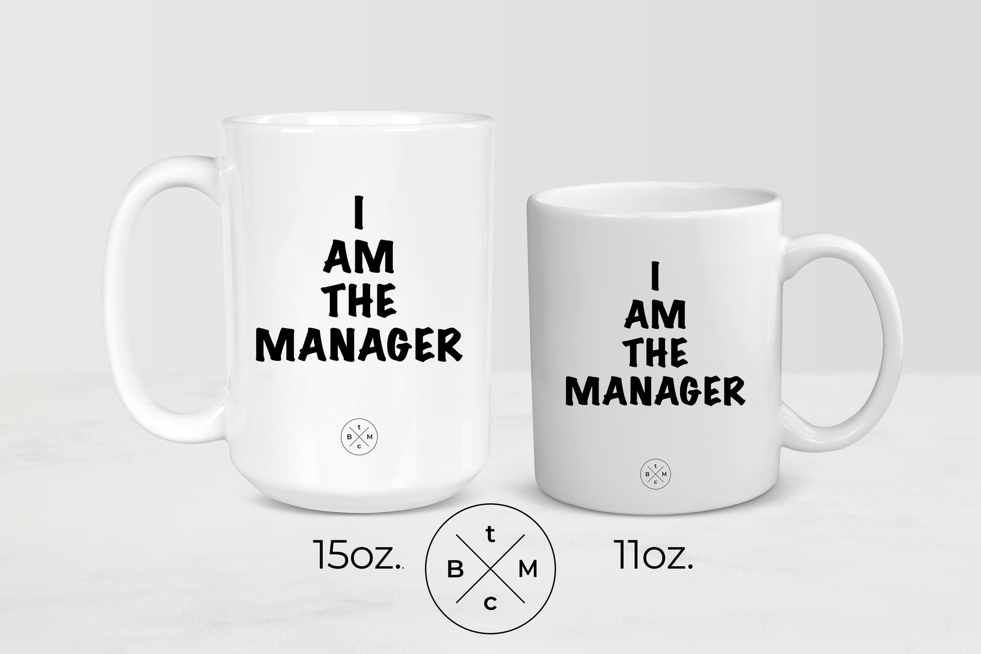 11 and 15 ounce white ceramic mugs with black text I am the manager