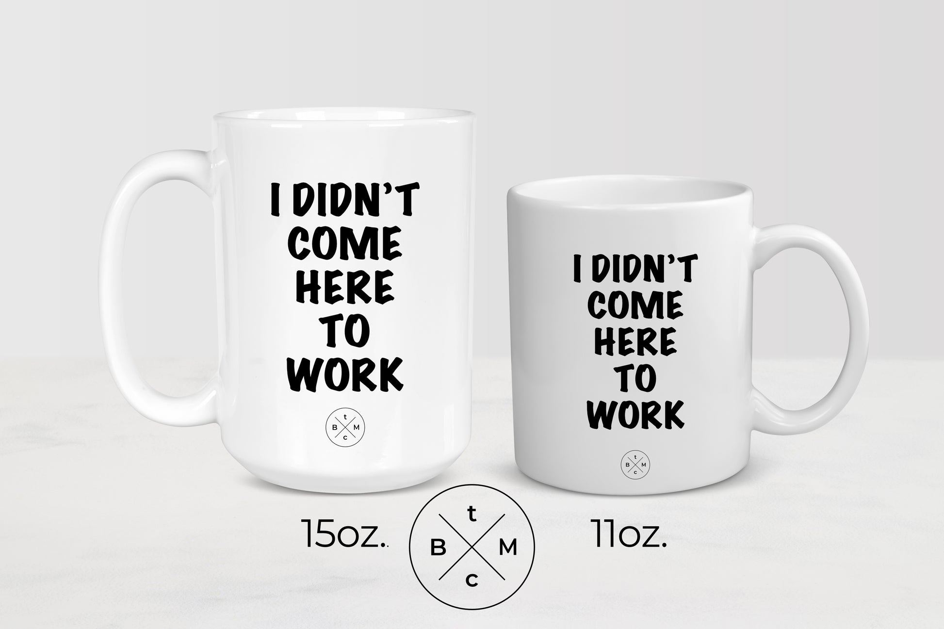 11 ounce and 15 ounce white ceramic mugs with black text I didn’t come to work