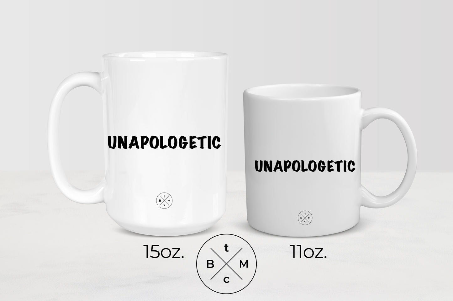 11 ounce and 15 ounce white ceramic mugs with black  text unapologetic