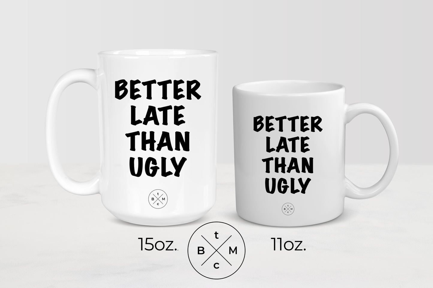 White 11 ounce and 15 ounce ceramic mugs with black text better late than ugly