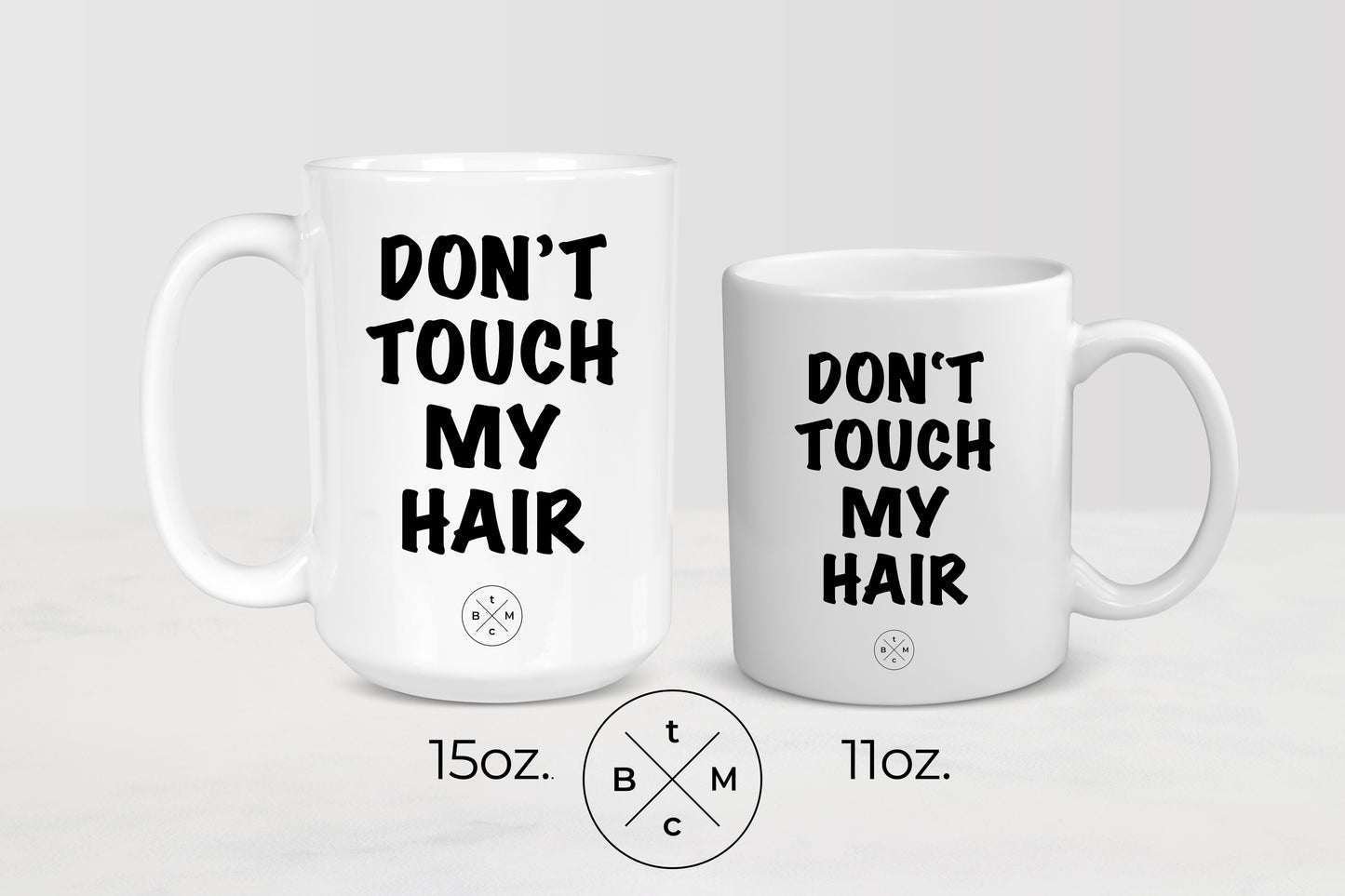 11 ounce and 15 ounce white ceramic mugs with black text don’t touch my hair