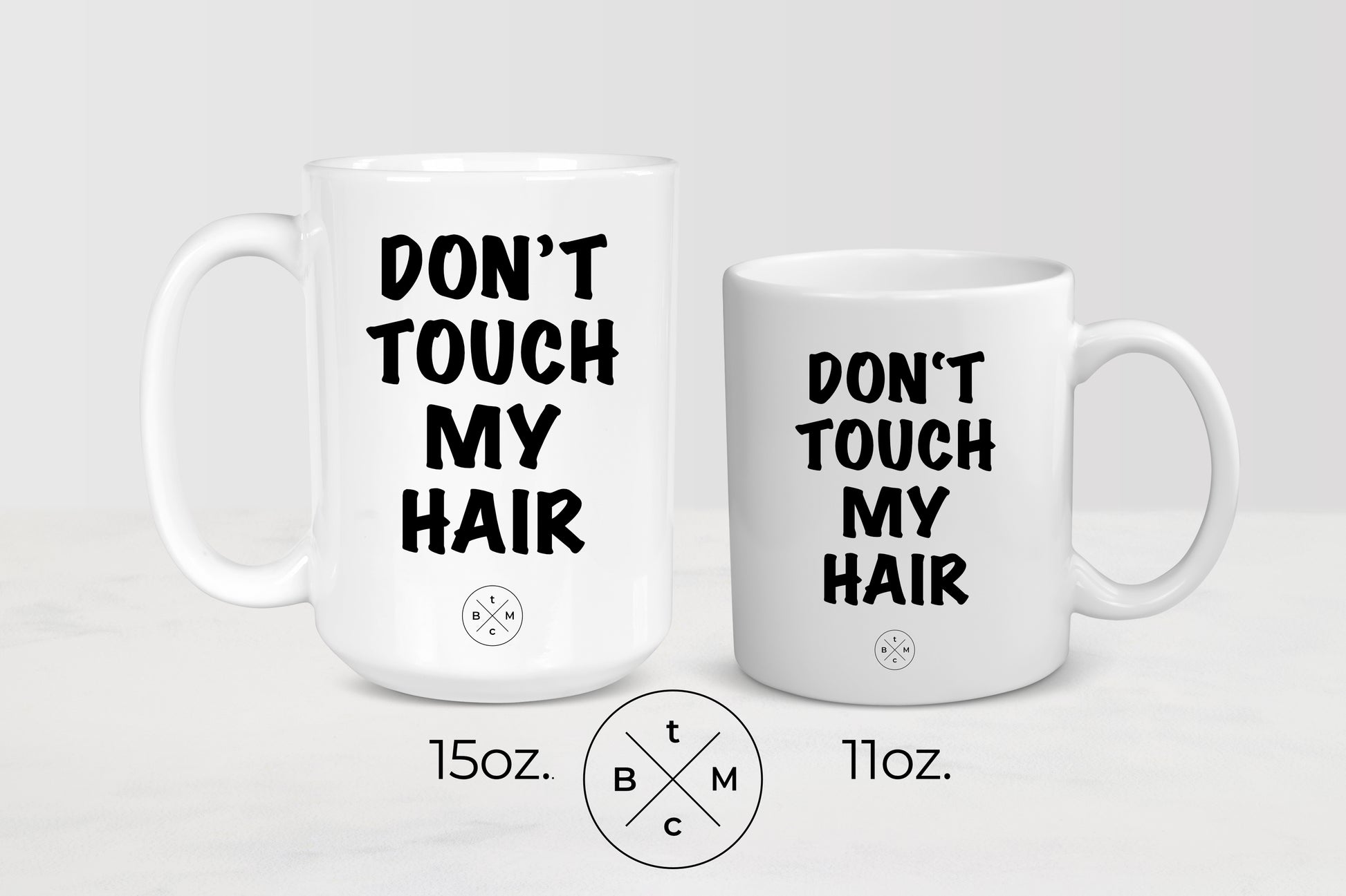 11 ounce and 15 ounce white ceramic mugs with black text don’t touch my hair