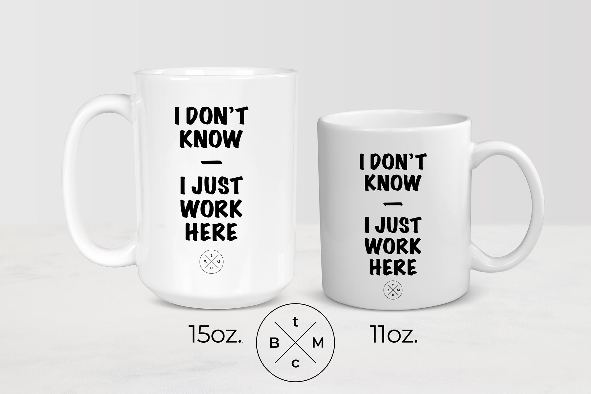 11 ounce and 15 ounce white ceramic mugs with black text I don’t know I just work here 