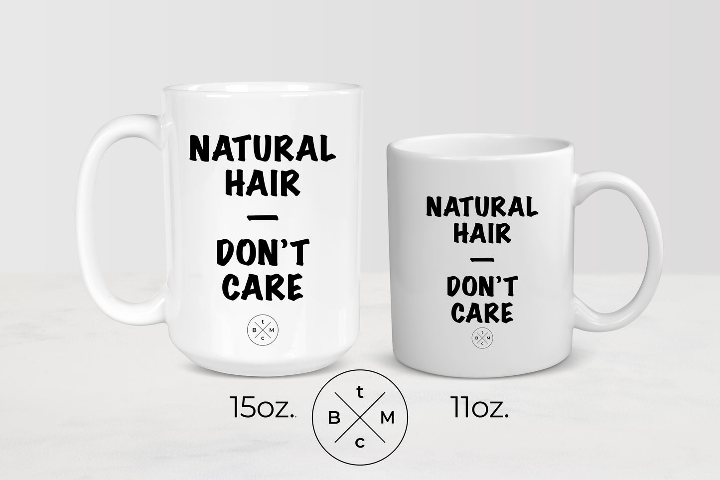 White 11 ounce and 15 ounce ceramic mugs with black text natural hair don’t care