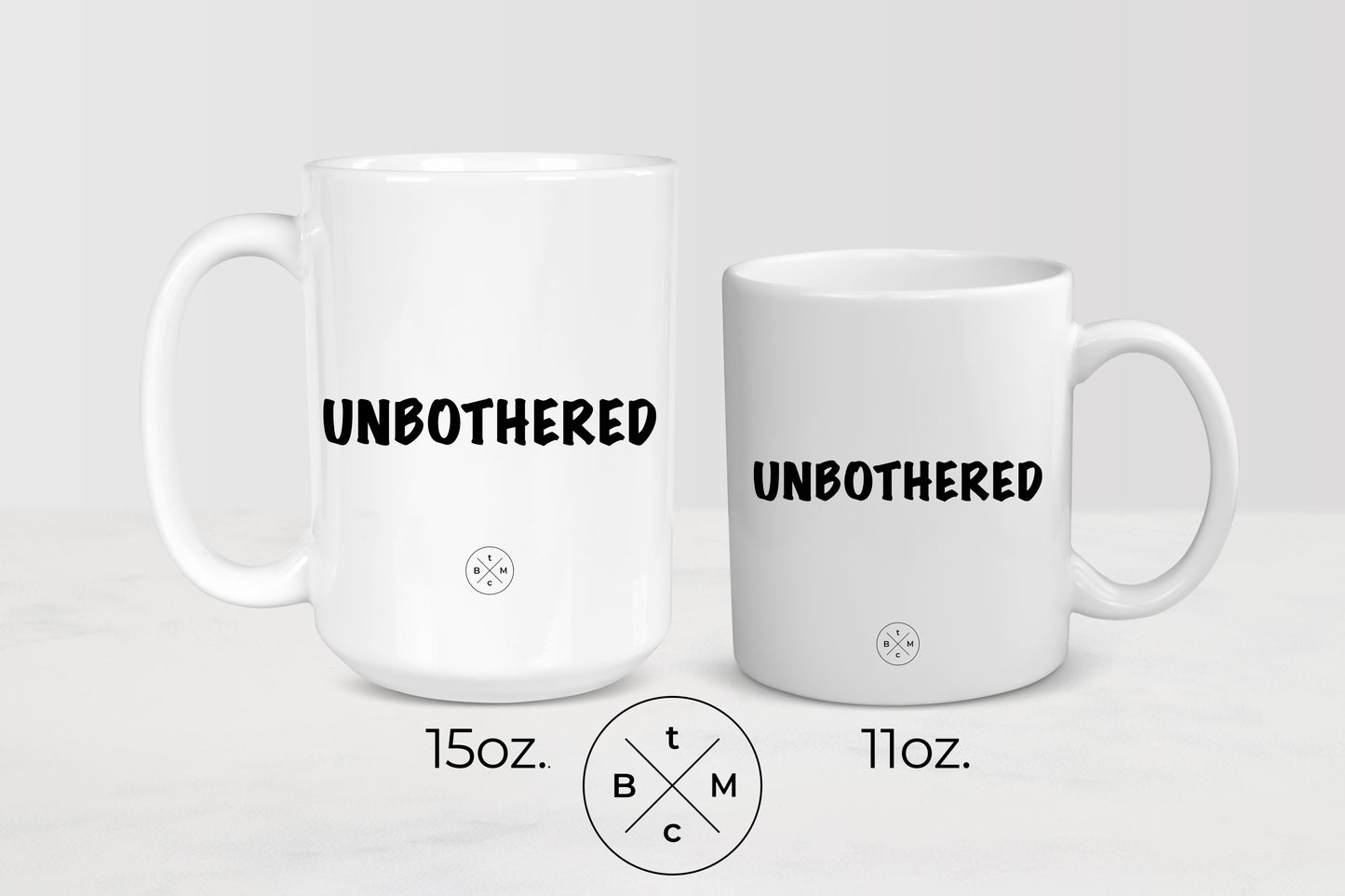  White 11 ounce and 15 ounce ceramic mugs with black text unbothered