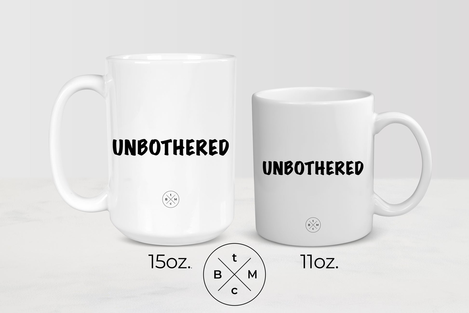  White 11 ounce and 15 ounce ceramic mugs with black text unbothered