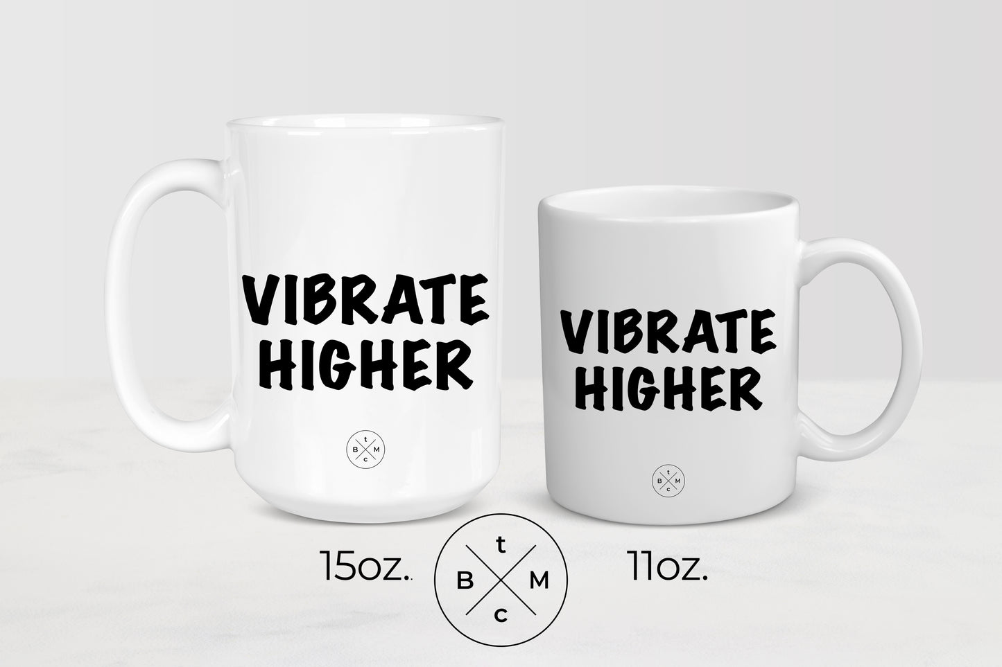 White 11 ounce and 15 ounce ceramic mugs with black text vibrate higher