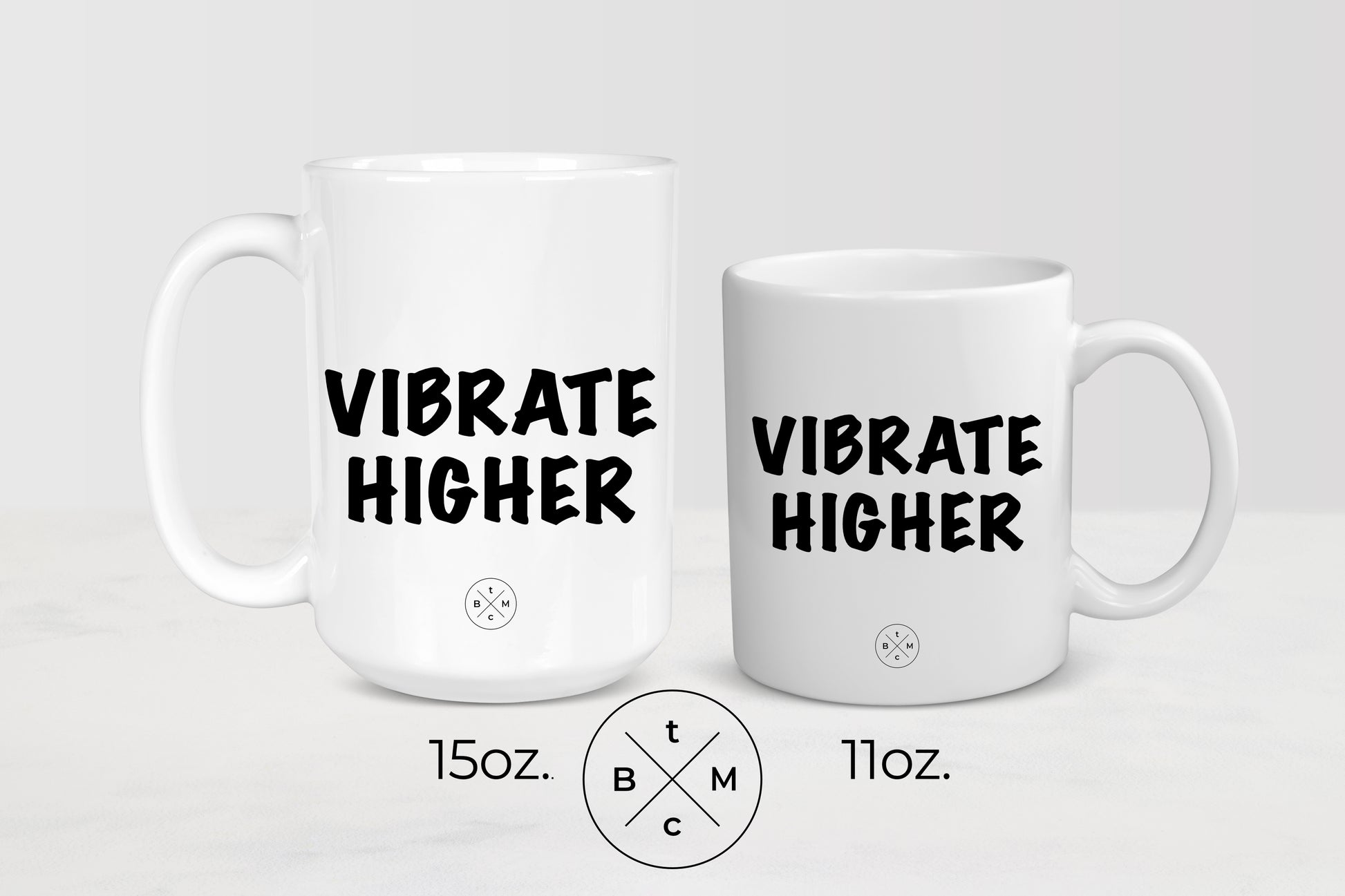 White 11 ounce and 15 ounce ceramic mugs with black text vibrate higher