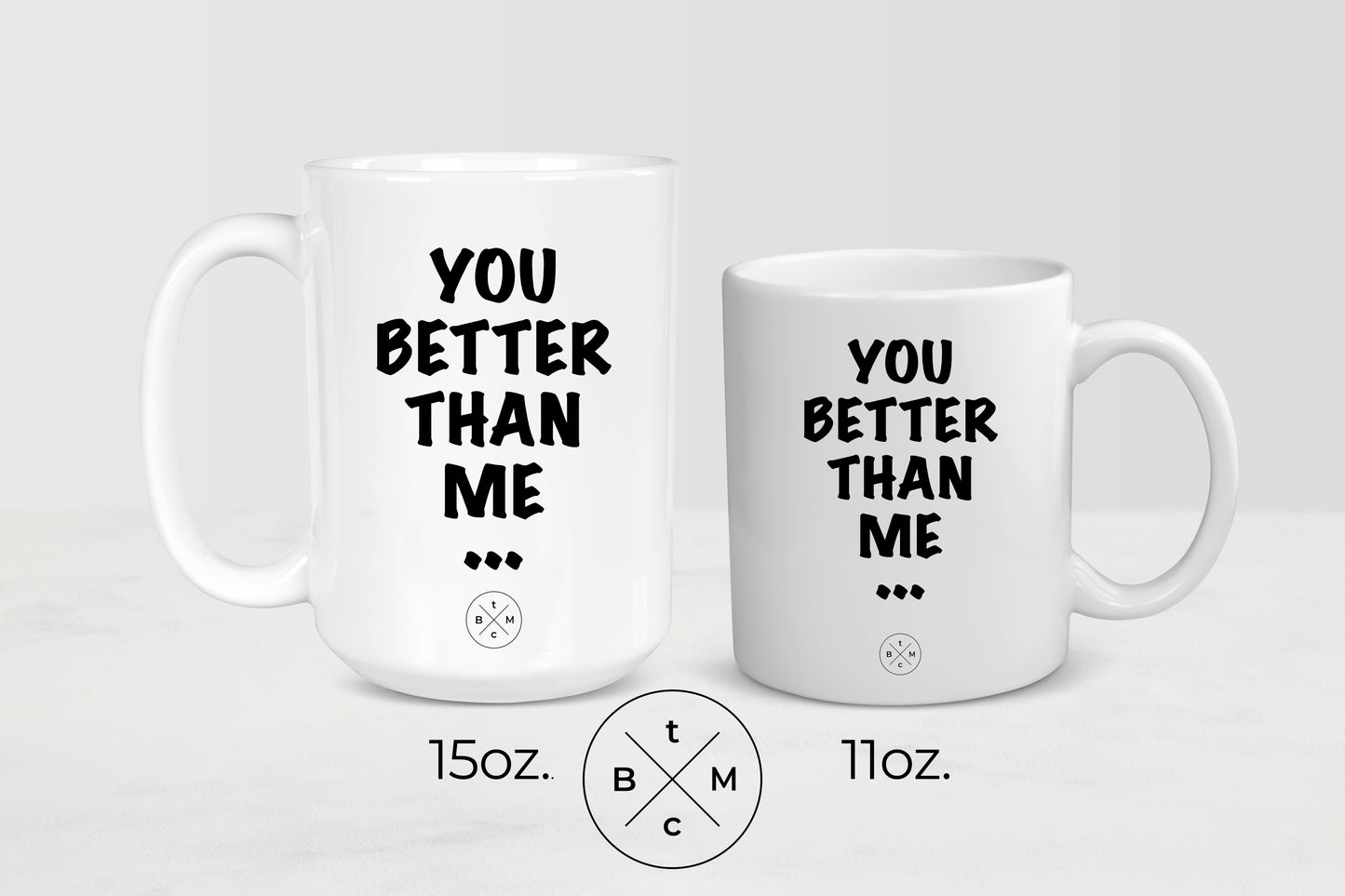 White 11 ounce and 15 ounce ceramic mugs with black text you better than me