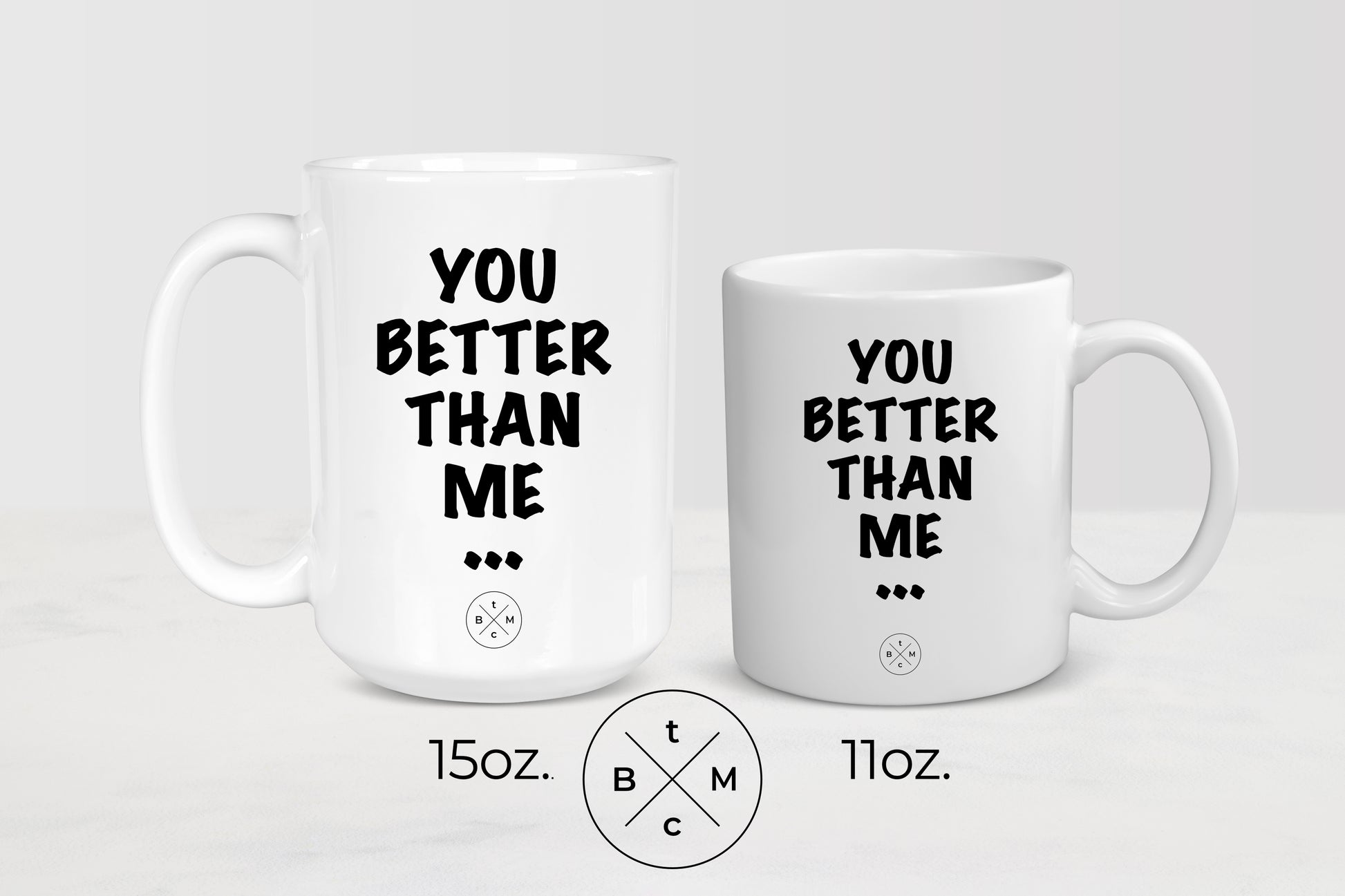 White 11 ounce and 15 ounce ceramic mugs with black text you better than me