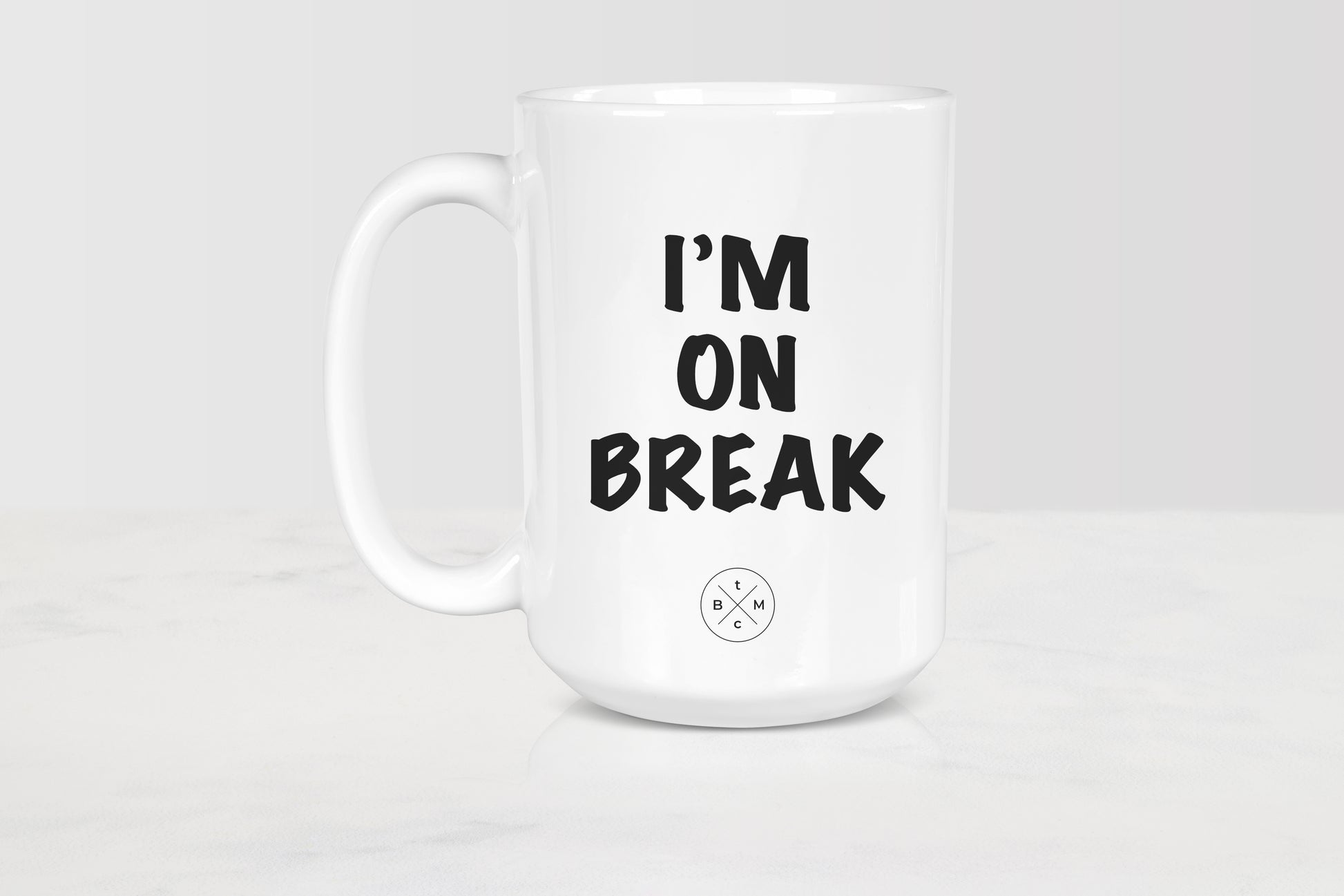 15 ounce white ceramic mug with black text I’m on break